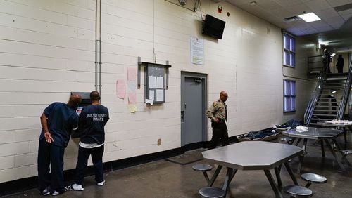 Inmates are seen using a kiosk in their cell block that allows them to schedule visits and medical appointments during a tour of the Fulton County Jail on Monday, December 9, 2019, in Atlanta. (Elijah Nouvelage/Special to the Atlanta Journal-Constitution)