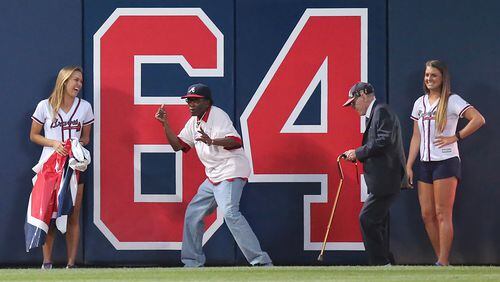 051016 ATLANTA: The Braves “dancing ushers” Herman Mills and Melvin Russ dance after tearing down number 65 changing it to 64 games left to play at Turner Field at the end of the fifth inning against the Phillies in a baseball game on Tuesday, May 10, 2016, in Atlanta. Curtis Compton / ccompton@ajc.com