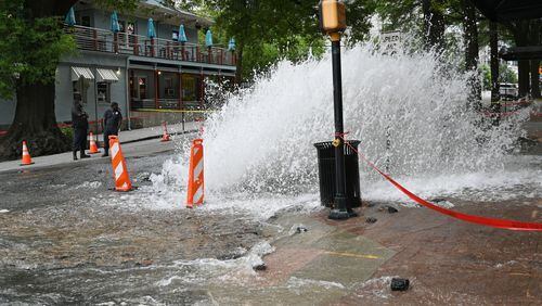 A water main break is seen at the corner of the corner of 11th Street and West Peachtree Street, Saturday, June 1, 2024, in Atlanta. A water main that ruptured, causing thousands to lose access to water around Atlanta, was repaired Saturday morning but water may take several hours to be restored. (Hyosub Shin / AJC)