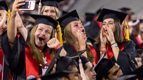 Graduates celebrate at Sanford Stadium during the University of Georgia spring commencement in Athens on Friday, May 10, 2024. (Arvin Temkar / AJC)