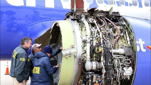 In this National Transportation Safety Board handout, NTSB investigators examine damage to the CFM International 56-7B turbofan engine belonging Southwest Airlines Flight 1380 that separated during flight Tuesday in Philadelphia. Investigators can’t explain with certainty why the left engine in the Boeing 737 malfunctioned but are directing their attention to metal fatigue on fan blades. One woman died during the incident. (Photo by Keith Holloway/National Transportation Safety Board via Getty Images)