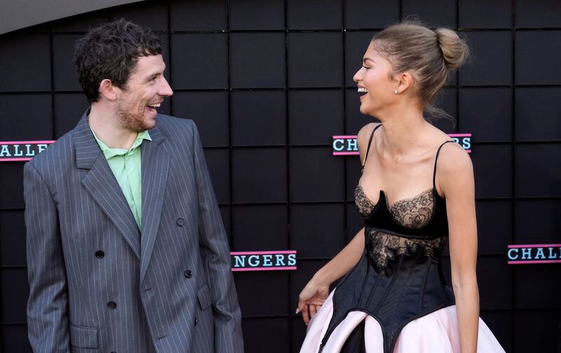 Josh O'Connor, left, and Zendaya, cast members in "Challengers," greet each other at the premiere of the film at the Regency Village Theatre, Tuesday, April 16, 2024, in Los Angeles. (AP Photo/Chris Pizzello)