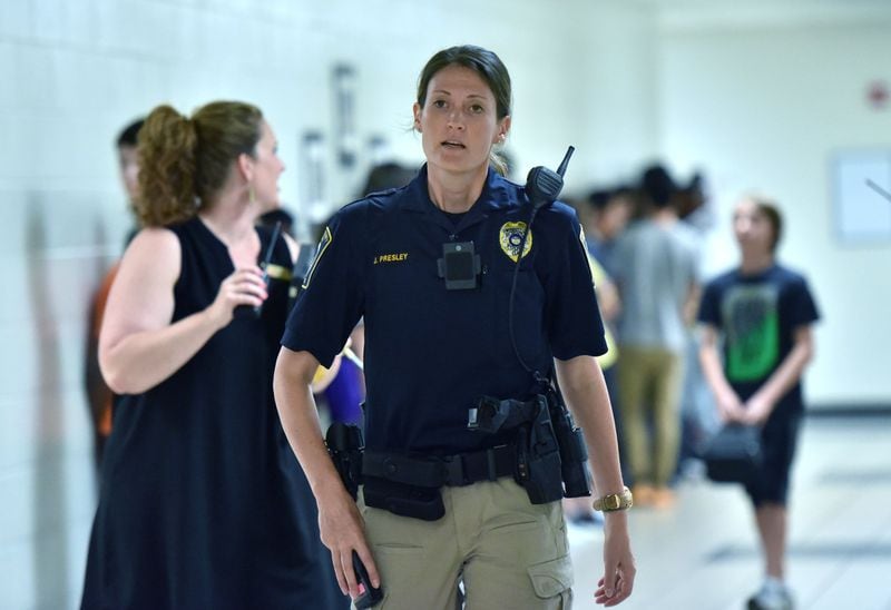 Jennifer Presley, school resource officer (SRO), conducts a routine check at Twin Rivers Middle School in Buford on Wednesday, May 10, 2017. School police departments are spreading across Georgia’s education system, but an AJC investigation has found a significant number of officers patrolling campuses have a checkered past. Gwinnett stands out for its stellar record. HYOSUB SHIN / HSHIN@AJC.COM