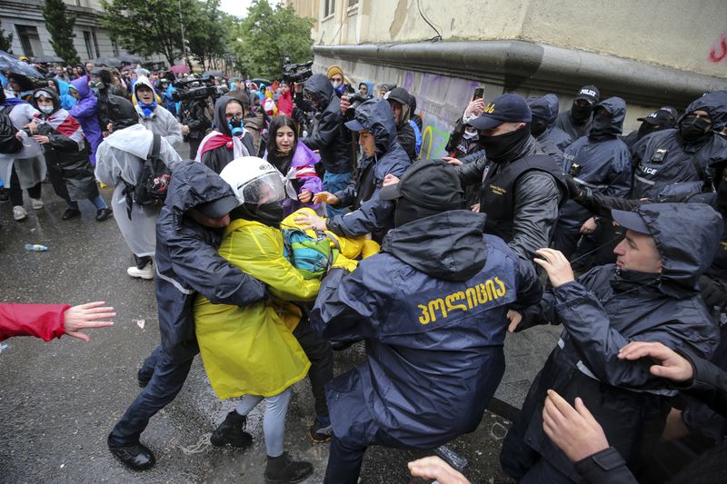Police try to detain a demonstrator near the Parliament building during an opposition protest against "the Russian law" in the center of Tbilisi, Georgia, on Monday, May 13, 2024. Daily protests are continuing against a proposed bill that critics say would stifle media freedom and obstruct the country's bid to join the European Union. (AP Photo/Zurab Tsertsvadze)