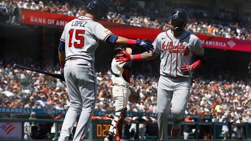 Orlando Arcia (11) of the Braves celebrates with Nicky Lopez (15) after hitting a solo home run in the top of the sixth inning against the San Francisco Giants at Oracle Park on Aug. 26, 2023, in San Francisco. (Lachlan Cunningham/Getty Images/TNS)