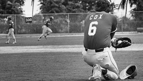 Braves manager Bobby Cox looks over his squad during spring training workout in 1980.