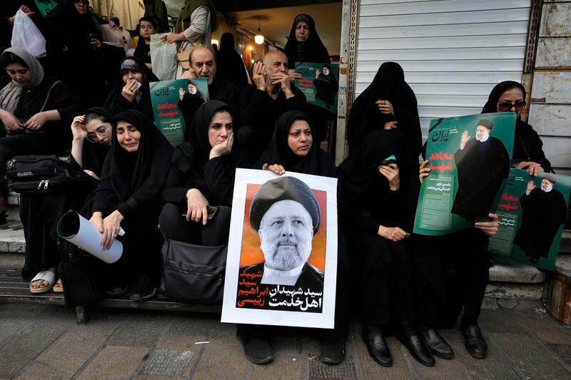 People hold up posters of Iranian President Ebrahim Raisi during a mourning ceremony for him at Vali-e-Asr square in downtown Tehran, Iran, Monday, May 20, 2024. President Raisi and the country's foreign minister were found dead Monday hours after their helicopter crashed in fog, leaving the Islamic Republic without two key leaders as extraordinary tensions grip the wider Middle East. (AP Photo/Vahid Salemi)