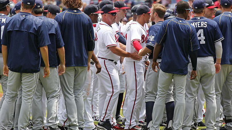 Braves manager Fredi Gonzalez (center) helps break up a bench-clearing confrontation after Braves pitcher Julio Teheran hit Padres batter Matt Kemp with a pitch during the first inning Thursday, June 11, 2015, at Turner Field in Atlanta.
