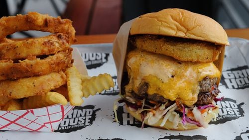 Grindhouse Dixie Style burger with pimento cheese, fried green tomato, Carolina cole slaw and chipotle ranch at Grindhouse Killer Burgers. / AJC file photo