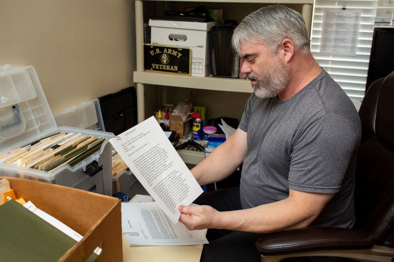 Bruce Barber keeps careful documentation of his health issues and of his attempts to get treatment for his service-related health conditions. (Photo/Rebecca Wright for the AJC)