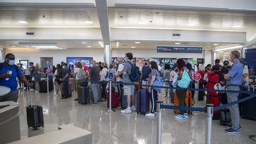 Delta Air Lines passengers check into their flights in the South Domestic Terminal during an early morning at Hartsfield-Jackson Atlanta International Airport, Tuesday, June 15, 2021. (Alyssa Pointer / Alyssa.Pointer@ajc.com)