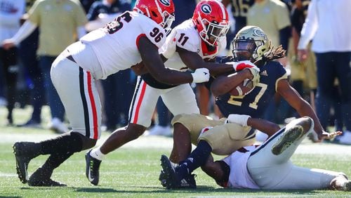 112721 Atlanta: Georgia defensive lineman Zion Logue (from left) and defensive back Derion Kendrick tackle Georgia Tech running back Jordan Mason for short yardage during the first half on the way to a 45-0 shut out in a NCAA college football game on Saturday, Nov. 27, 2021, in Atlanta.   “Curtis Compton / Curtis.Compton@ajc.com”`