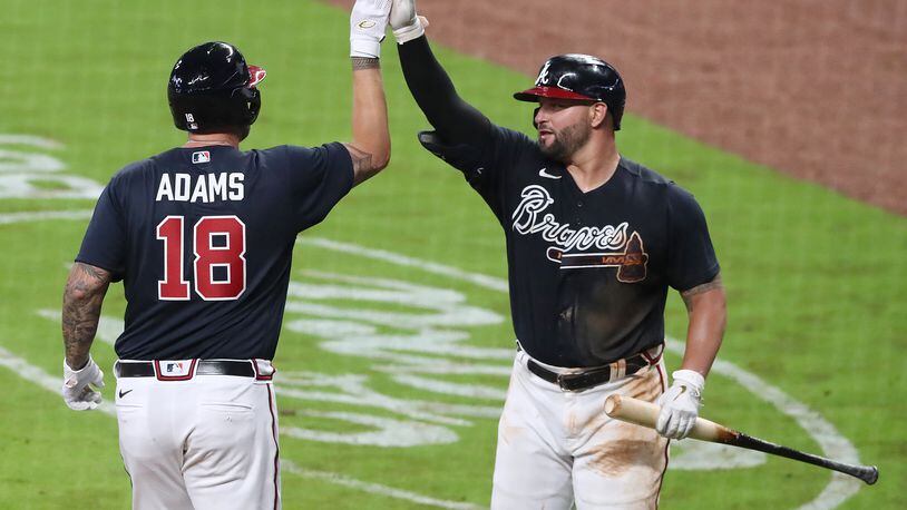 Welcome back, Matt Adams: Yonder Alonso greets the new Brave Adams following his home run that put a pin in Tuesday night's exhibition game against the Miami Marlins. Curtis Compton ccompton@ajc.com