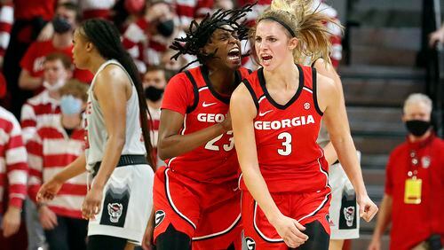 Georgia's Sarah Ashlee Barker (3) celebrates with teammate Que Morrison (23) after making a 3-point basket with one second remaining to send the Bulldogs into overtime against No. 2-ranked N.C. State. The No. 14 Bulldogs (9-1) prevailed 82-80 in Raleigh, N.C. (AP Photo/Karl B. DeBlaker)