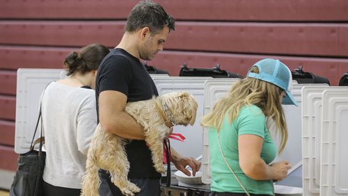 November 7, 2017 Atlanta: Garrett Clum brought his dog, Beau to vote on Tuesday. Voters lined up early at Henry W. Grady High School at 929 Charles Allen Dr NE in Atlanta on Tuesday, Nov. 7, 2017 to cast their votes. Only about 20,000 of 250,000 registered votersÂ cast early ballots in Atlantaâs mayoral election, a likely sign of low turnout for Tuesdayâs vote to succeed Atlanta Mayor Kasim Reed. A late WSB-TV poll, released on Friday,Â showed Councilwoman Keisha Lance Bottoms leading Councilwoman Mary Norwood for the first time with 25 percent of the vote to Norwoodâs 23 percent. Â JOHN SPINK/JSPINK@AJC.COM