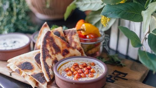 Ela offers three hummus options, including this one featuring crispy chickpeas and sumac. The trio also is available as a $15 sampler, with grilled pita. Courtesy of Frankie Cole