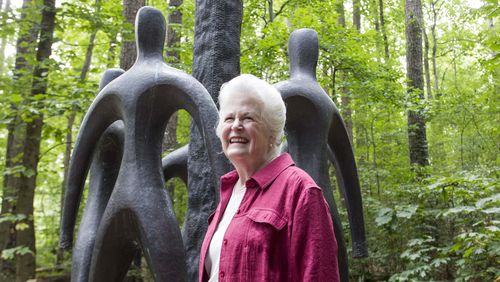 Laura Dorsey at the first site designated a Garden for Peace, the 5-acre Swan Woods at the Atlanta History Center. The centerpiece is this 14-foot bronze sculpture by Georgi Jataridze.