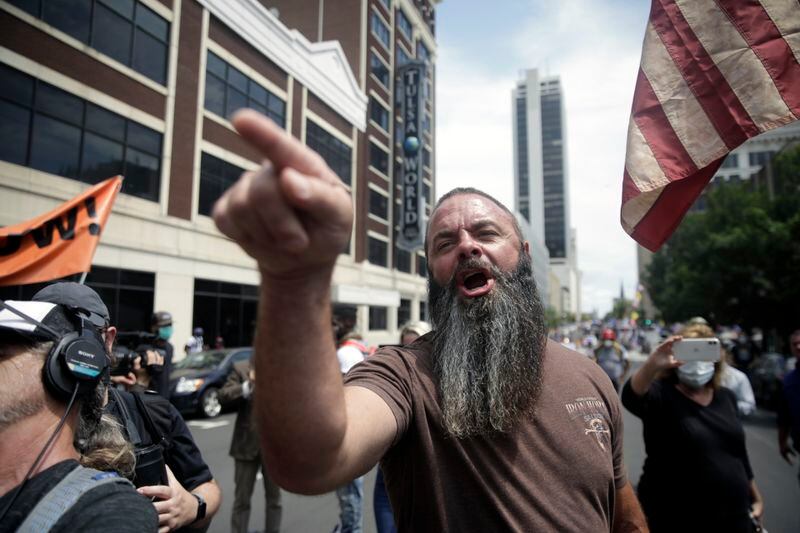 Trump supporters and opponents clash at Fourth and Denver a few blocks away from the BOK Center before President Trump's planned rally, Saturday, June 20, 2020 in Tulsa, Okla. (Mike Simons/Tulsa World via AP)