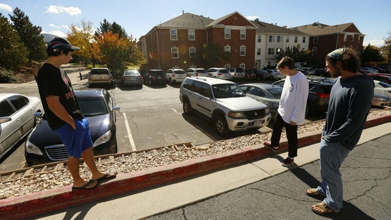 University of Utah students stand near the campus parking lot where student and track athlete Lauren McCluskey, 21, was shot to death by her ex-boyfriend Oct. 22, 2018.