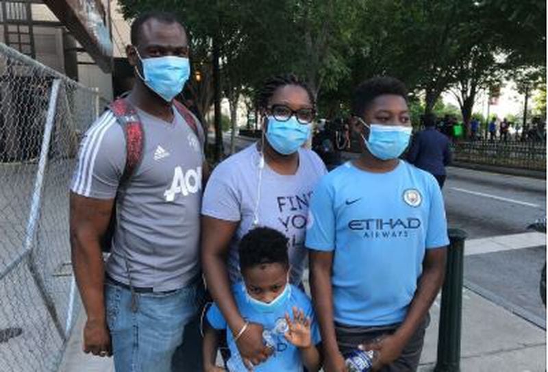 Jaylon Ryan-Aymer and his family protest Monday in Atlanta.