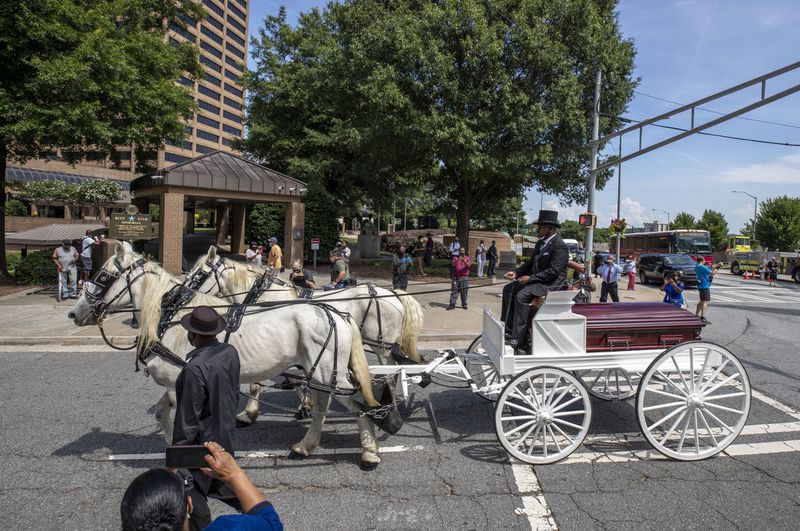 07/22/2020 - Atlanta, Georgia - A horse drawn carriage carries the body of C.T. Vivian down Capital Avenue SW toward the historic Sweet Auburn District in Atlanta, Wednesday, July 22, 2020. VivianÕs body laid in state in the rotunda of the building to celebrate his life. (ALYSSA POINTER / ALYSSA.POINTER@AJC.COM)