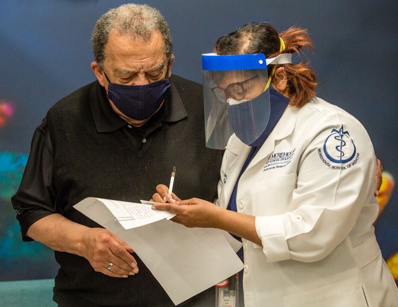 Morehouse School of Medicine on Jan. 5 administers the first of two Moderna Covid-19 vaccines to civil rights leaders including Ambassador Andrew Young and sets up reminders for the second dose.  (Jenni Girtman for The Atlanta Journal-Constitution)