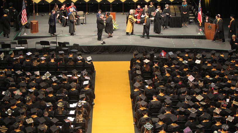 May 10, 2017, Atlanta, Georgia - Students along with their family and friends from Kennesaw State University in the College of Humanities and Social Sciences attend their Commencement ceremony to graduate from the university in Kennesaw, Georgia, on May 10, 2017. Two new reports show the state of Georgia is committing a smaller percentage of money for college costs. (HENRY TAYLOR / HENRY.TAYLOR@AJC.COM)