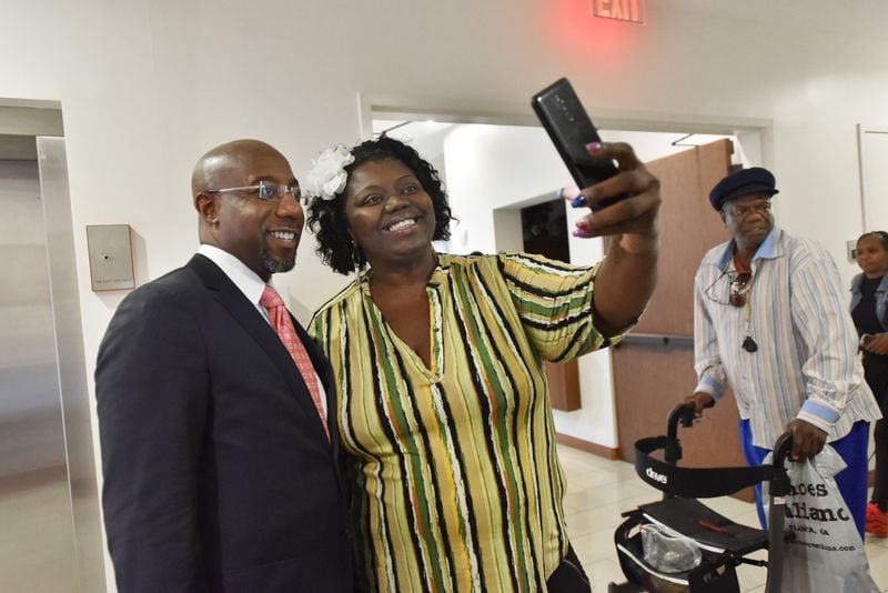 The Rev. Raphael Warnock (left) takes a selfie with program participant Stephanie Morley during the Good Neighbor Program at Ebenezer Baptist Church on July 18, 2019. HYOSUB SHIN / HYOSUB.SHIN@AJC.COM