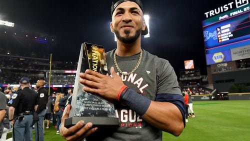 Braves left fielder Eddie Rosario holds the Most Valuable Player trophy after the 4-2 win against the Los Angeles Dodgers. Hyosub Shin / Hyosub.Shin@ajc.com