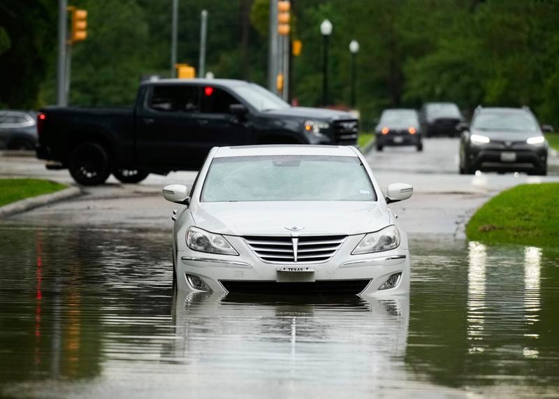 A stalled car is seen in flood water near North Park Drive after severe flooding, Thursday, May 2, 2024, in the Houston neighborhood of Kingwood, Texas. (Jason Fochtman/Houston Chronicle via AP)