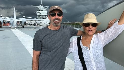Larry and Nancy Feinberg of Charleston, S.C., watch storm clouds from the deck of the USS Yorktown, where an eclipse-watching party of 2,500 will gather on Aug. 21. BO EMERSON / BEMERSON@AJC.COM