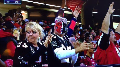 Long-time Atlanta Falcons season ticket holders Nancy Chapman, left, and Mark Chapman shown on television after a Falcons touchdown during a game earlier this season against San Francisco. Photo submitted by Clay Hall.