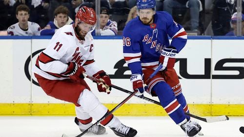 New York Rangers center Jack Roslovic (96) skates with the puck past Carolina Hurricanes center Jordan Staal in the first period during Game 5 of an NHL hockey Stanley Cup second-round playoff series, Monday, May 13, 2024, in New York. (AP Photo/Adam Hunger)