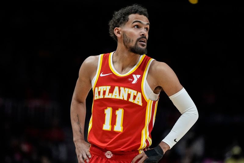 Atlanta Hawks guard Trae Young (11) walks up the court against the Charlotte Hornets during the first half of an NBA basketball game, Wednesday, April 10, 2024, in Atlanta. (AP Photo/Mike Stewart)
