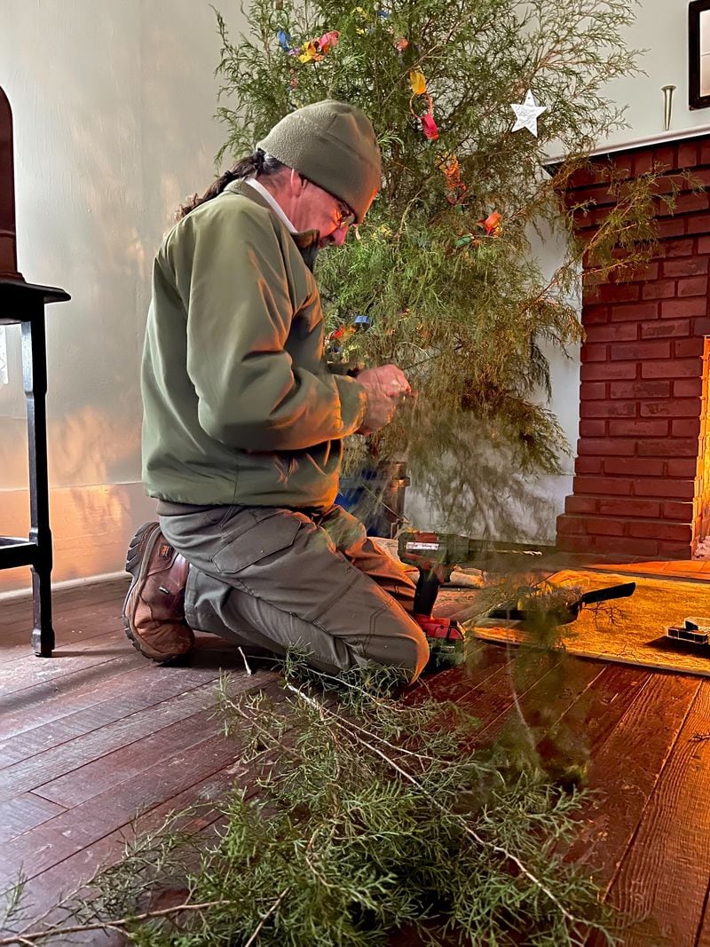 Ron Hobkirk, Jimmy Carter National Historical Park, places extra branches on the Jimmy Carter Boyhood Home's Christmas tree to fill it out.