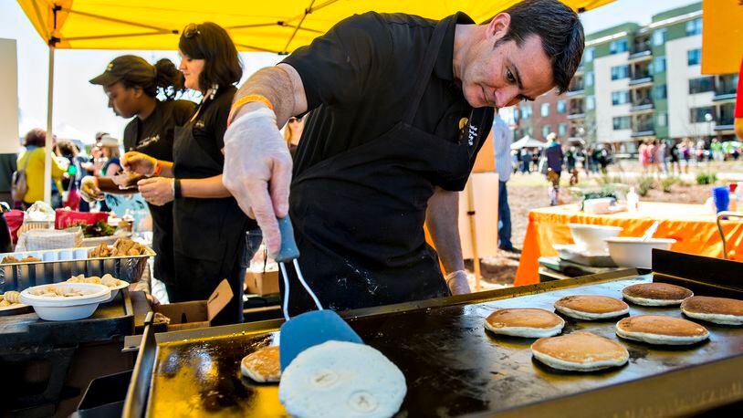 Bryan Fitzsimmons (center) checks to see if his pancake is ready to flip as he serves up brunch with Another Broken Egg Cafe at the Atlanta Brunch Festival at Fourth Ward Park in Atlanta on Saturday, March 5, 2016. Six thousand people came out to taste brunch from 41 restaurants and food trucks, drink mimosas and bloody marys, and listen to music. JONATHAN PHILLIPS / SPECIAL