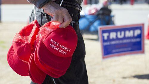 A vendor sells “Make America Great Again” hats before a rally for then-candidate Donald Trump in North Augusta, S.C., in February 2016. Today’s writer, a Cobb County high school student, says the election of President Trump has changed race relations for the worse among his peers. Stephen B. Morton/The New York Times
