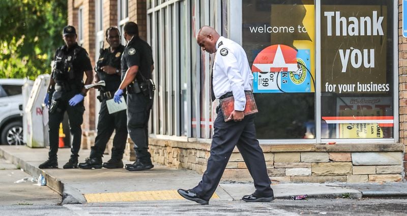 Atlanta police Deputy Chief Charles Hampton Jr. (center) was on the scene of a deadly stabbing Monday morning at a southwest Atlanta Texaco.