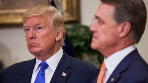 President Donald J. Trump and U.S. Sen. David Perdue, a Georgia Republican, listen during an announcement on immigration reform in August 2017. Photo by: Zach Gibson/picture-alliance/dpa/AP Images