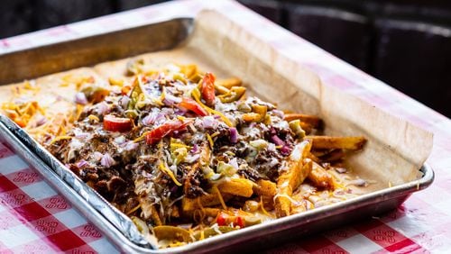 The Greater Good BBQ’s chili cheese fries are topped with house-made smoked jalapeno queso. CONTRIBUTED BY HENRI HOLLIS