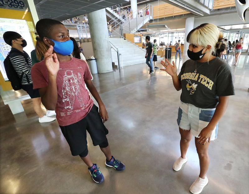 Third-year student Andrea Avila, 20, pauses to welcome 13-year-old Georgia Tech student Caleb Anderson to campus after his chemistry lab in the G. Wayne Clough Undergraduate Learning Commons at Georgia Tech on Wednesday, August 25, 2021, in Atlanta. Anderson has become the youngest student on Georgia Tech's campus.  (Curtis Compton / Curtis.Compton@ajc.com)