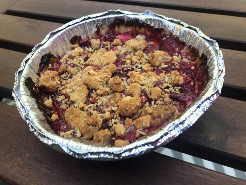 BoccaLupo’s baked strawberry crumble, with steel-cut oat streusel and creme anglaise, straddles the line between sweet and tart. LIGAYA FIGUERAS / LIGAYA.FIGUERAS@AJC.COM