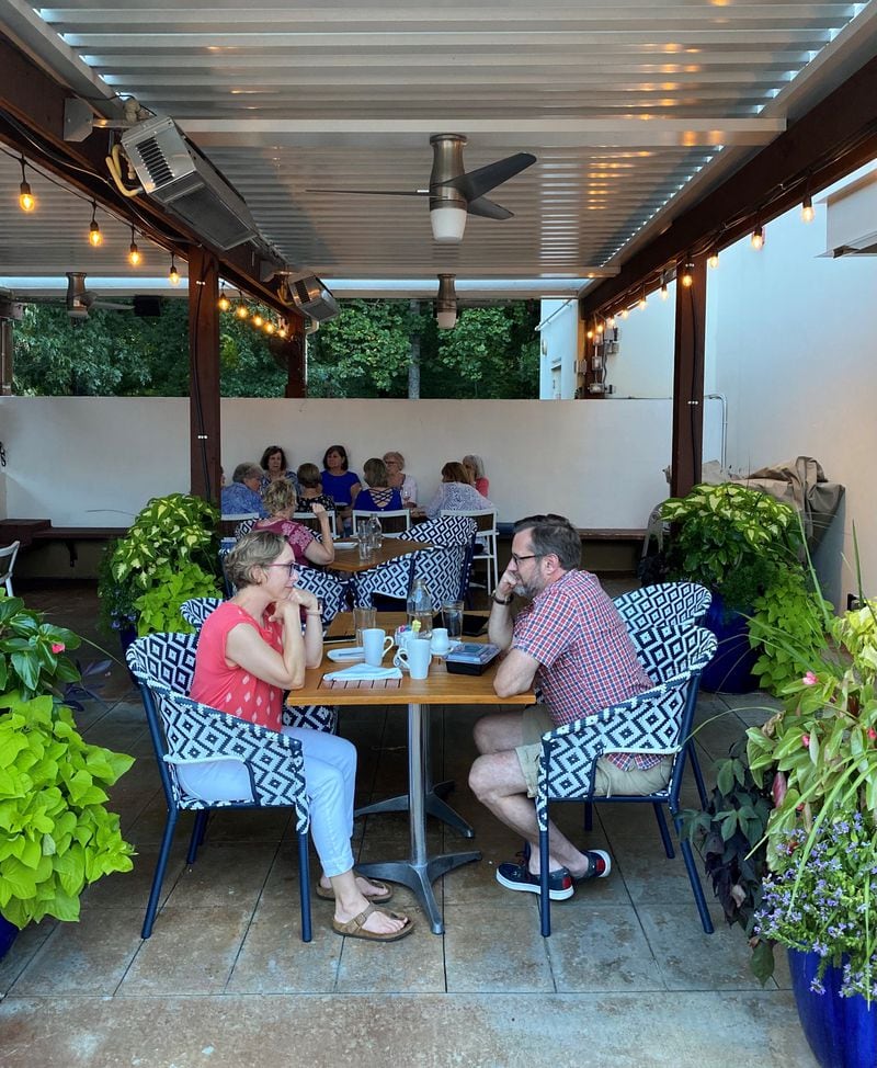 The patio at Seed Kitchen & Bar offers cool, shaded respite on hot summer days and nights. (Wendell Brock for The Atlanta Journal-Constitution)