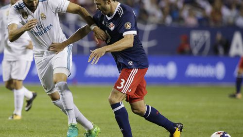 Real Madrid's Karim Benzema, left, and MLS All-Stars' Michael Parkhurst vie for the ball during the second half of the MLS All-Star Game, Wednesday, Aug. 2, 2017, in Chicago. Real Madrid won the game. (AP Photo/Nam Y. Huh)