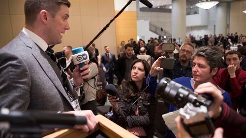 In this Nov. 18, 2016, photo, Richard Spencer, left, talks to the media at an Alt Right conference hosted by the National Policy Institute in Washington. CNN and host Jake Tapper have both apologized for an on-screen banner that Tapper said was "unacceptable" and "horrified" him when it appeared during his show on Monday, Nov. 21, 2016. The offending phrase appeared during a discussion among Jim Sciutto, subbing for Tapper on "The Lead," and two journalists about President-elect Donald Trump's support from the alt-right. The segment focused on white nationalist leader Spencer, whose anti-Semitic declarations Sciutto characterized as "hate-filled garbage." (Linda Davidson/The Washington Post via AP)