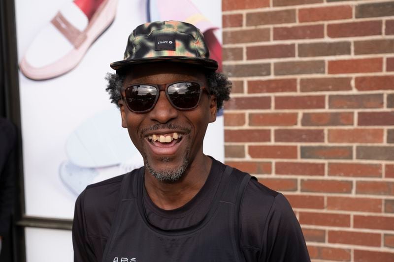 Maurice Garland, a run lead with the Atlanta Run Club, mingles before the start of their Monday night run at Ponce City Market on Monday, March 25, 2024.   (Ben Gray / Ben@BenGray.com)