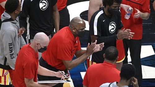 Atlanta Hawks interim coach Nate McMillan, center, encourages the team during a timeout in the second half of an NBA basketball game against the Orlando Magic, Wednesday, March 3, 2021, in Orlando, Fla. (AP Photo/Phelan M. Ebenhack)
