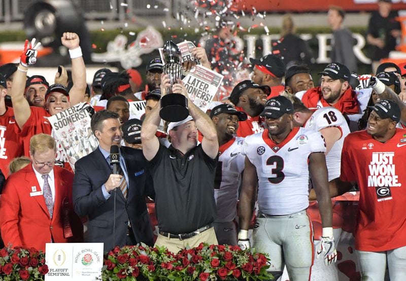 Georgia head coach Kirby Smart holds up the Rose Bowl trophy during the College Football Playoff Semifinal between Georgia and Oklahoma at Rose Bowl Stadium in Pasadena, Calif., on Mon, Jan. 1, 2018. HYOSUB SHIN / HSHIN@AJC.COM