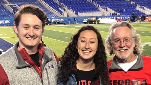Tim Hutchison (R), his son, Gunnar, and daughter, Claudia, are pictured here at the Georgia-Kentucky game in Lexington, Ky., on Nov. 3, 2018. They are lifelong Georgia fans, even though they always have lived in southern Indiana and never attended UGA. Hutchison and his son will be attending the national championship game between the Bulldogs and Alabama on Monday in Indianapolis. (Family photo)