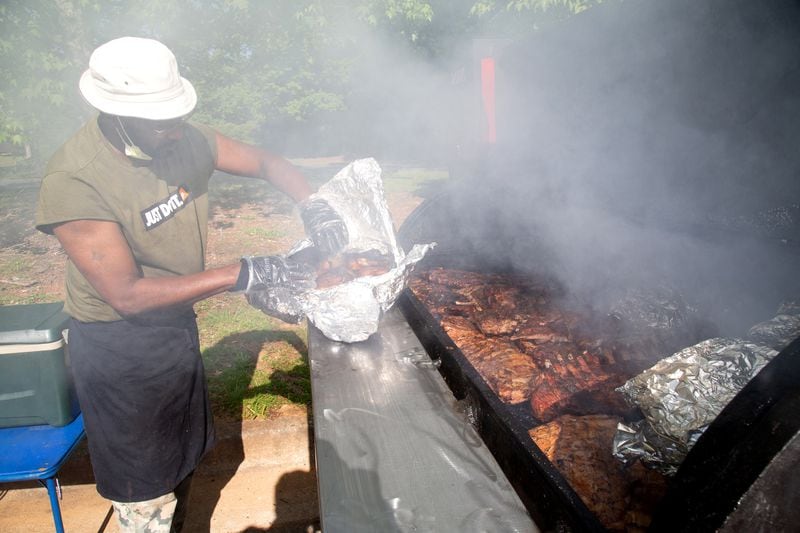 Edward Spence of Spence Barbecue works on barbecue orders at his location along Stone Hogan Connector SW in Atlanta Saturday, April 27, 2019.   STEVE SCHAEFER / SPECIAL TO THE AJC